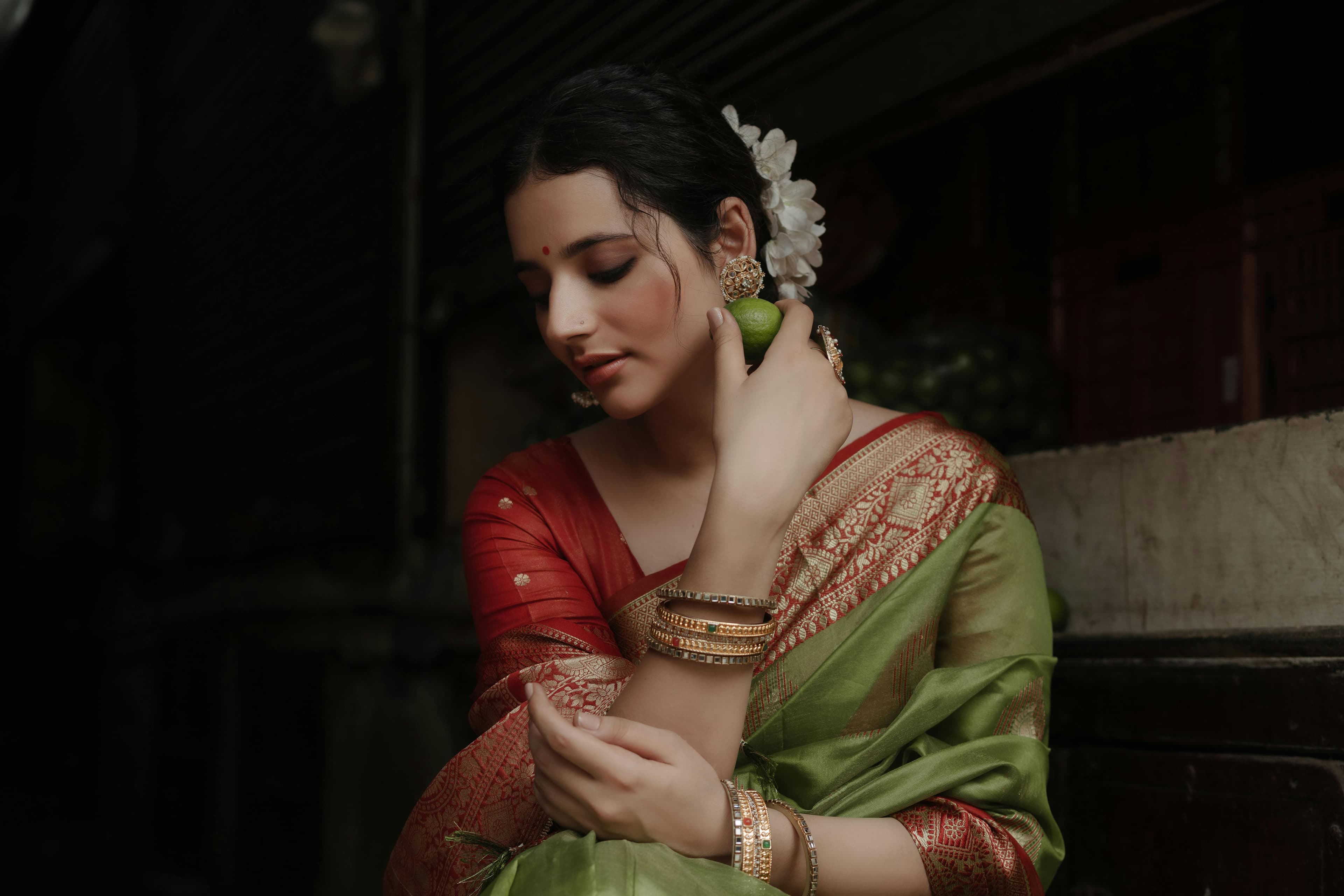Woman in green and red silk saree