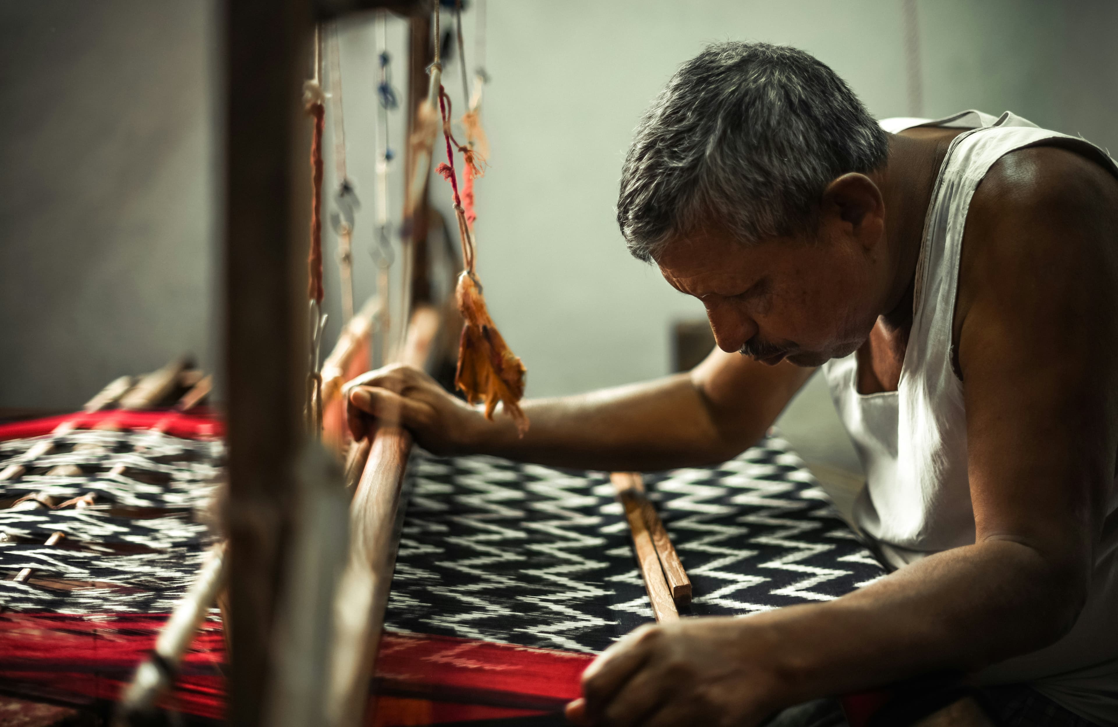 Weaver at ikat loom